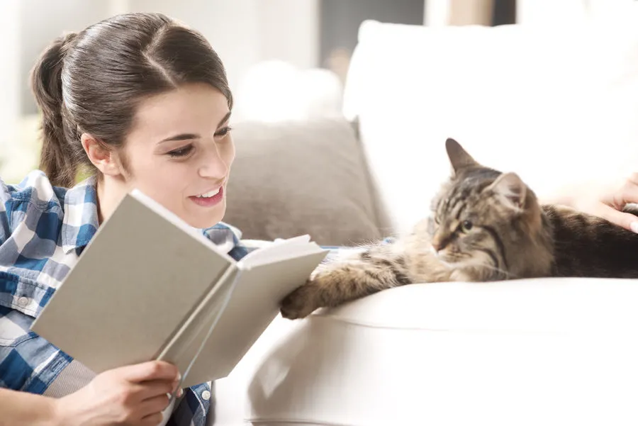 woman reading to cat