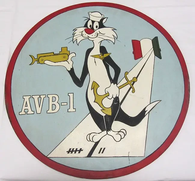 Holding an anchor and a submarine, an image of Sylvester appears on the badge of the USS Alameda County.  